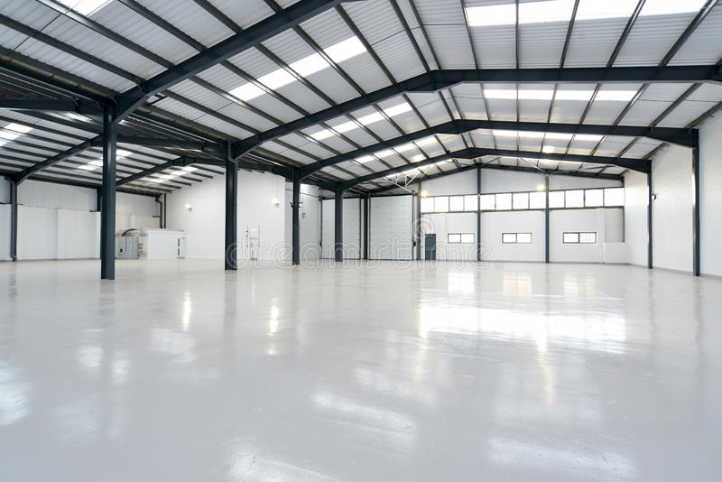 empty-warehouse-empty-warehouse-unit-shiny-floor-158243064.jpg