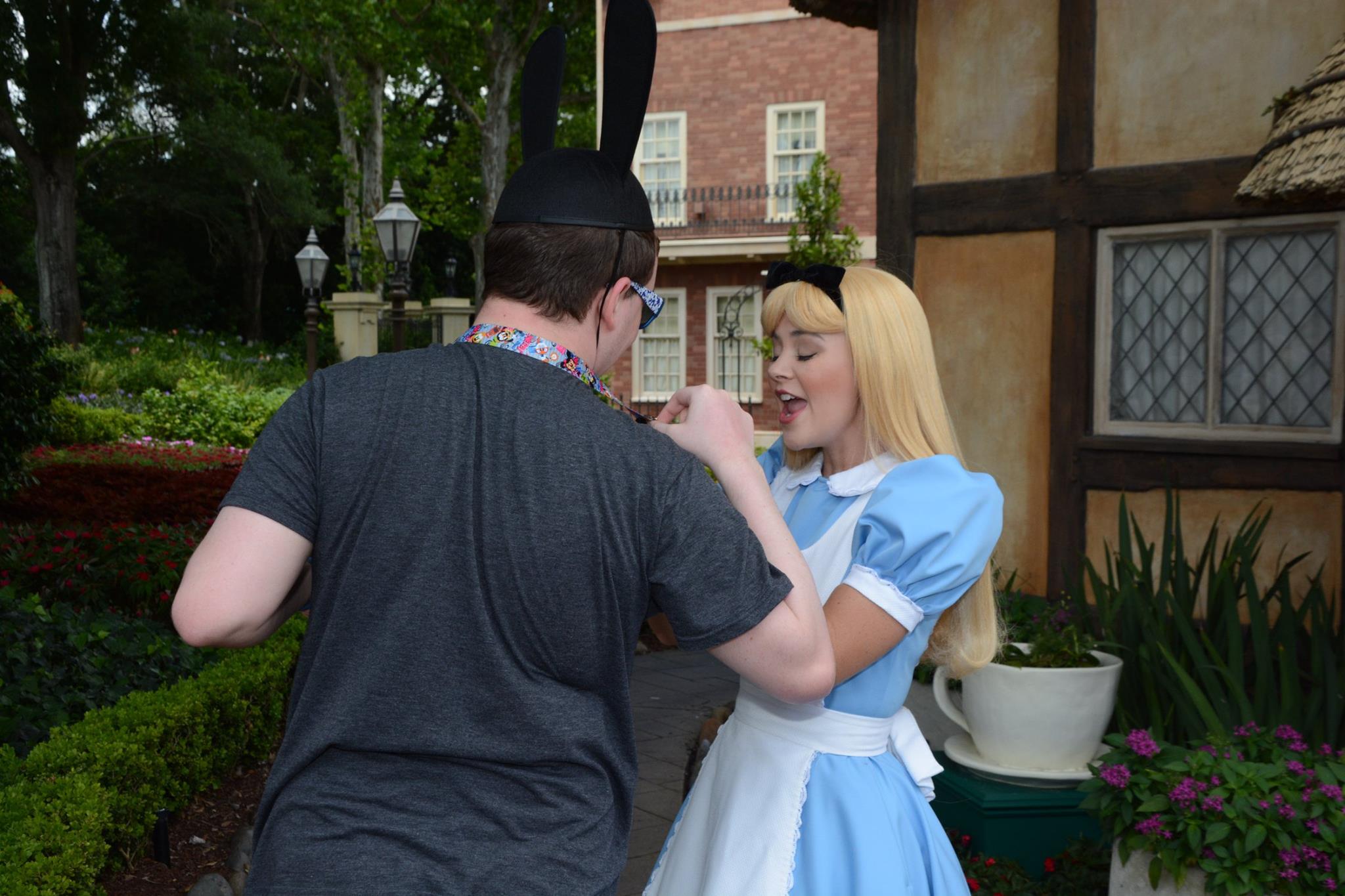 Showing Alice my Cheshire Cat Pin